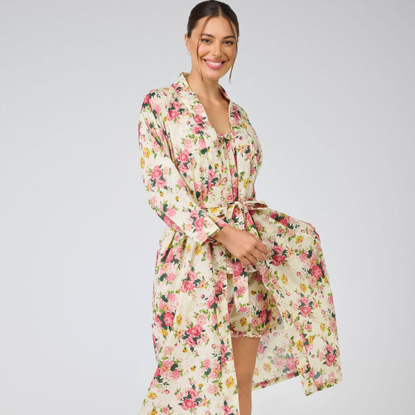 Woman wearing a floral robe on a plain background