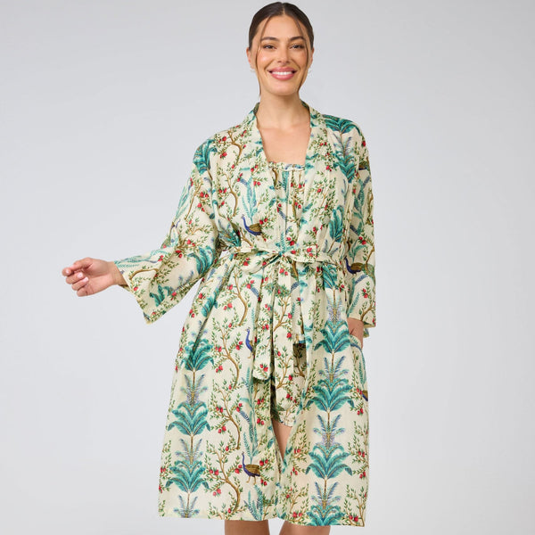 Woman wearing a floral patterned robe on a plain background