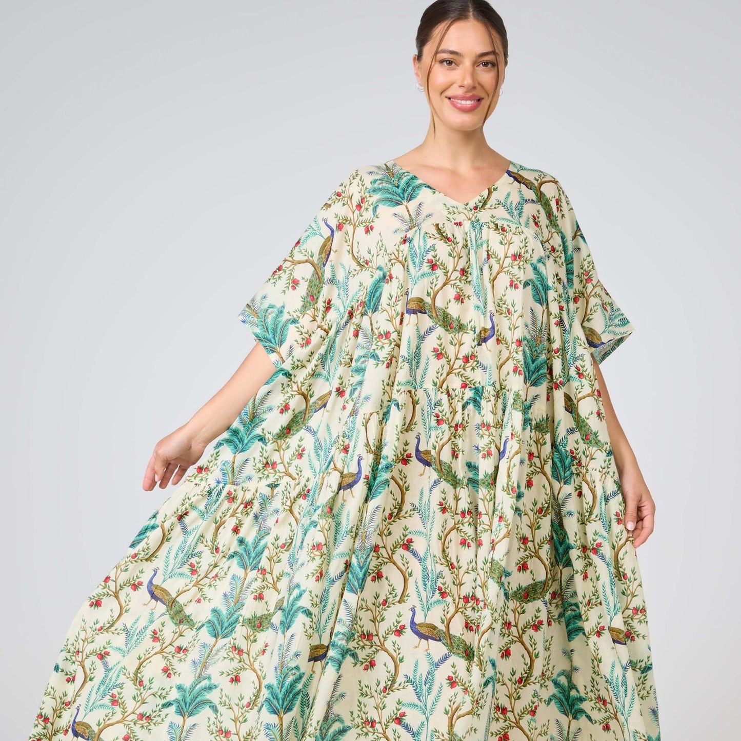 Woman wearing a floral dress with a plain background