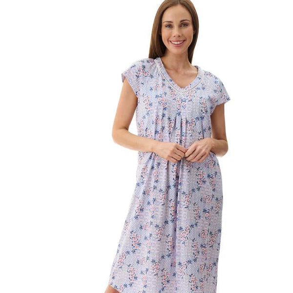 Woman wearing a floral nightgown on a white background