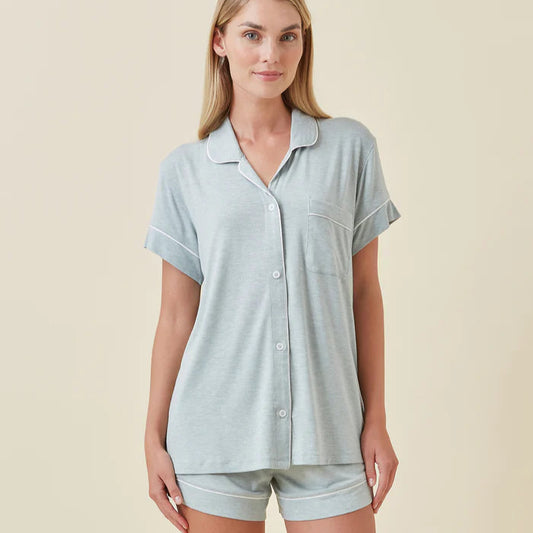 Woman wearing a light blue pajama set on a beige background
