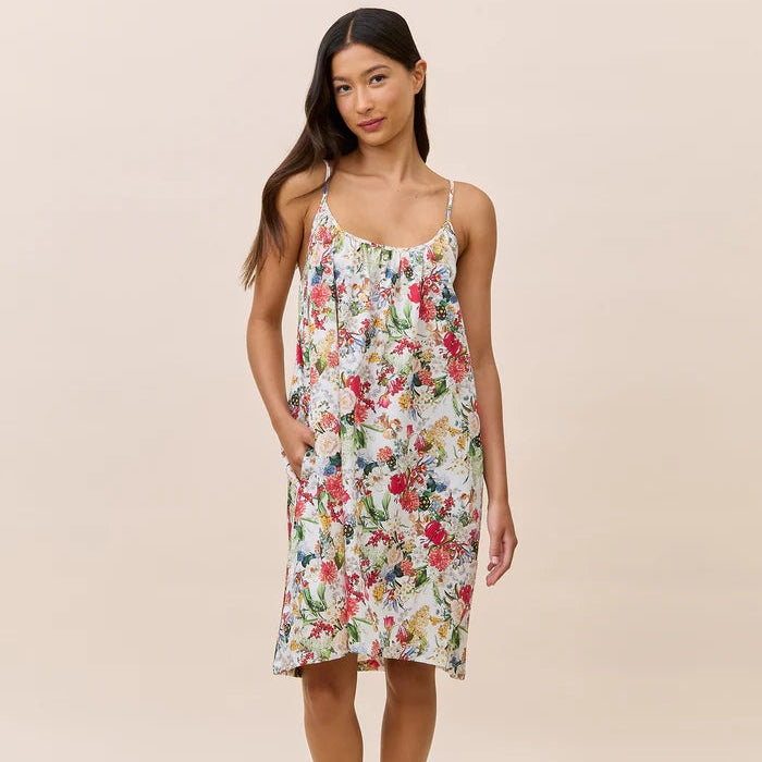 Woman wearing a floral nightdress against a beige background