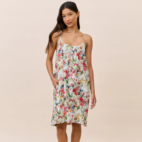 Woman wearing a floral nightdress against a beige background