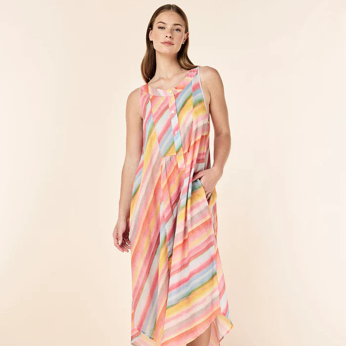 Woman wearing a colorful striped dress on a beige background