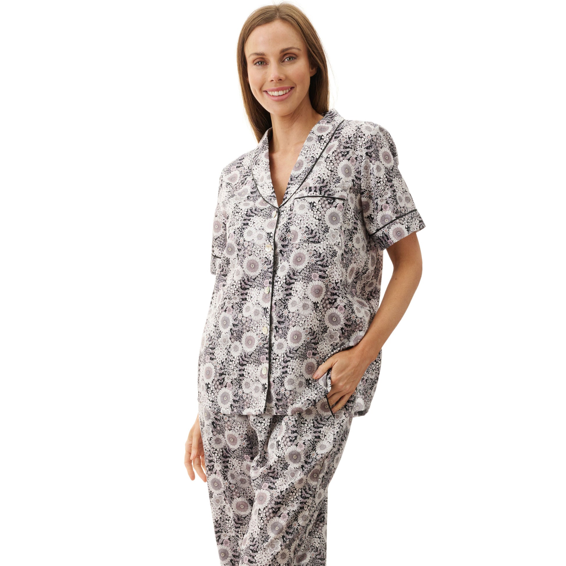 Woman wearing a floral pajama set on a white background