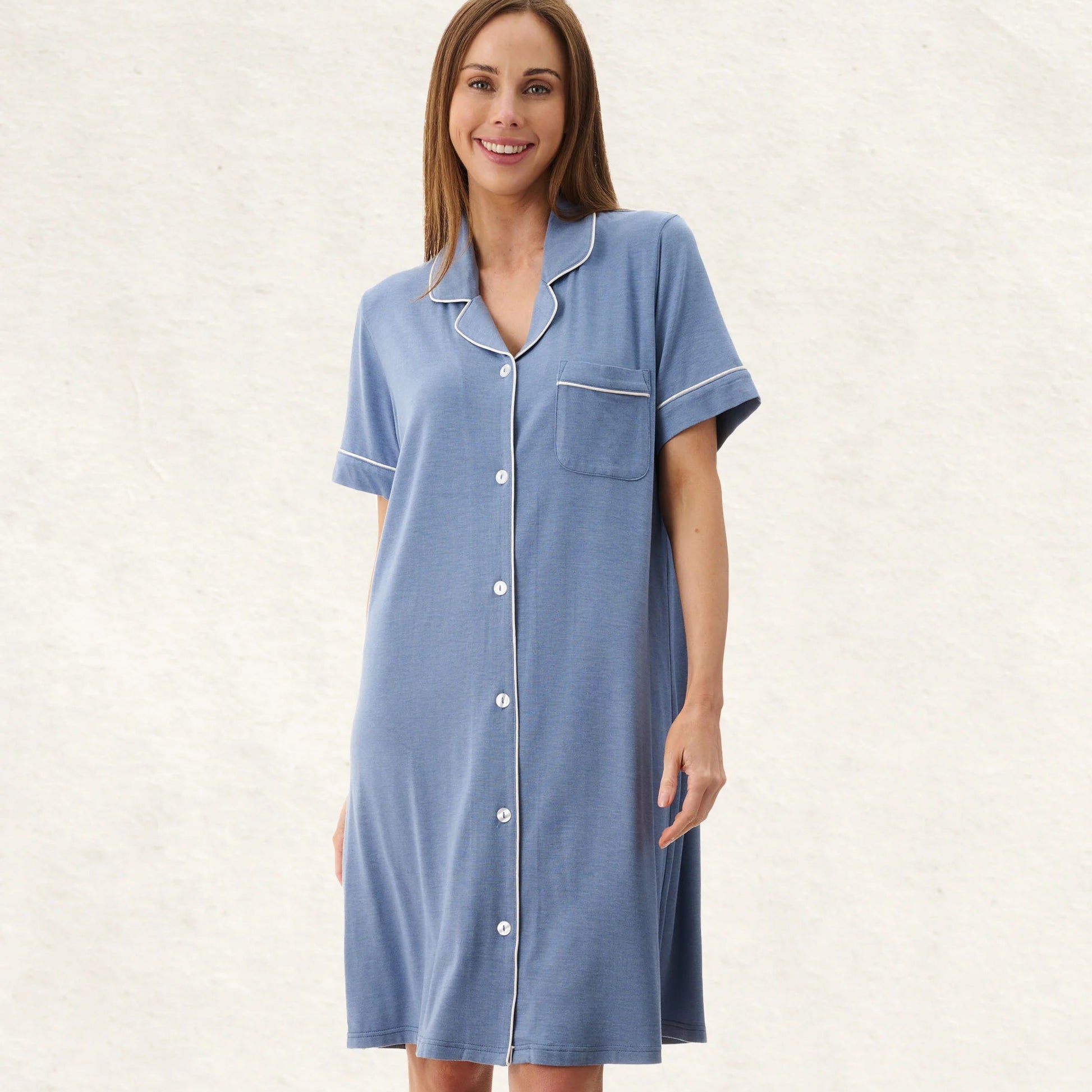 Woman wearing a blue nightshirt on a white background